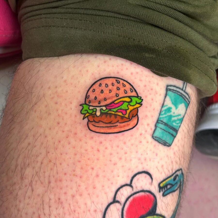 Playful burger tattoo brings joy to ink. Tattoo on skin