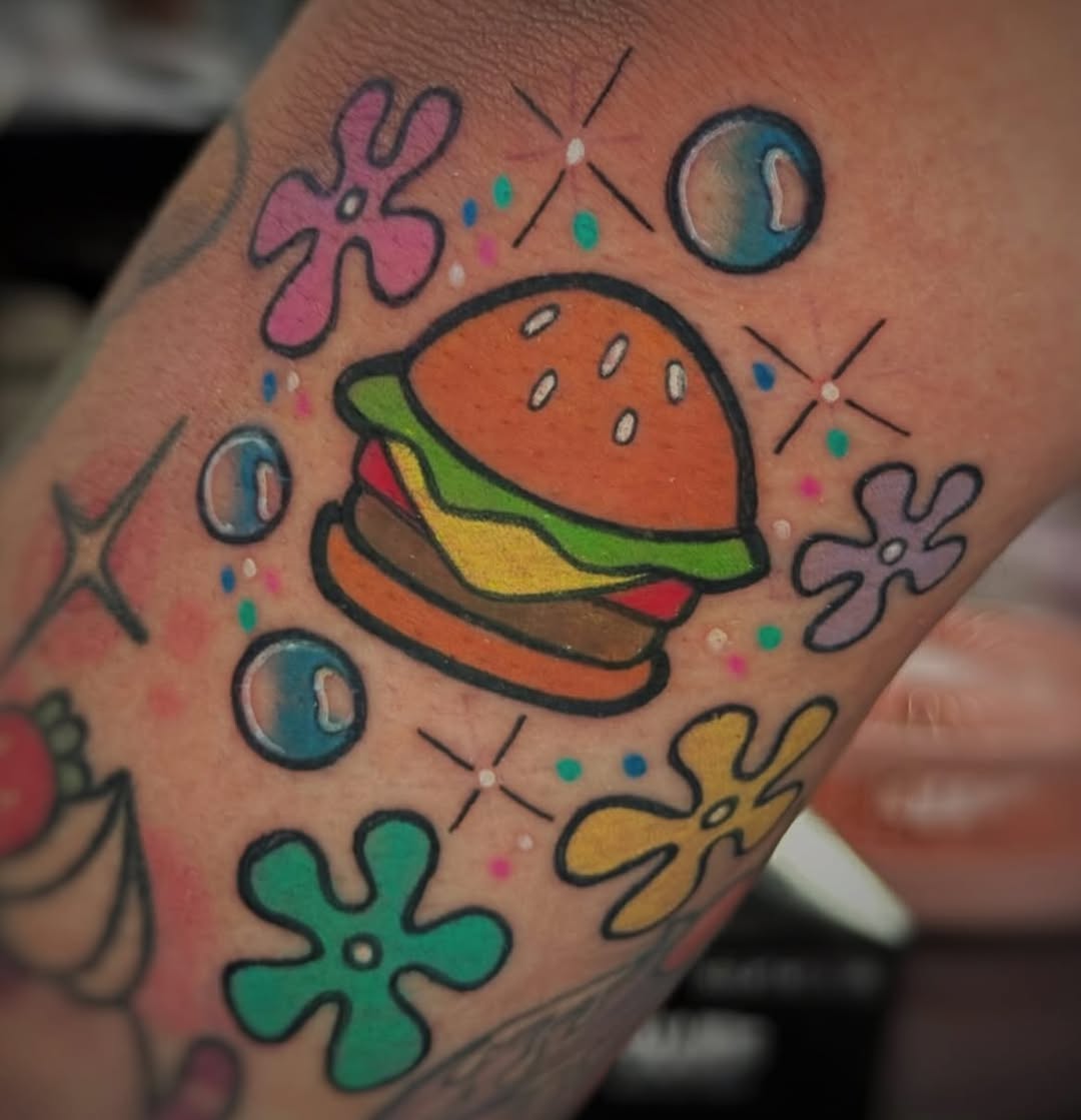 Playful burger tattoo with colorful accents burger tattoos