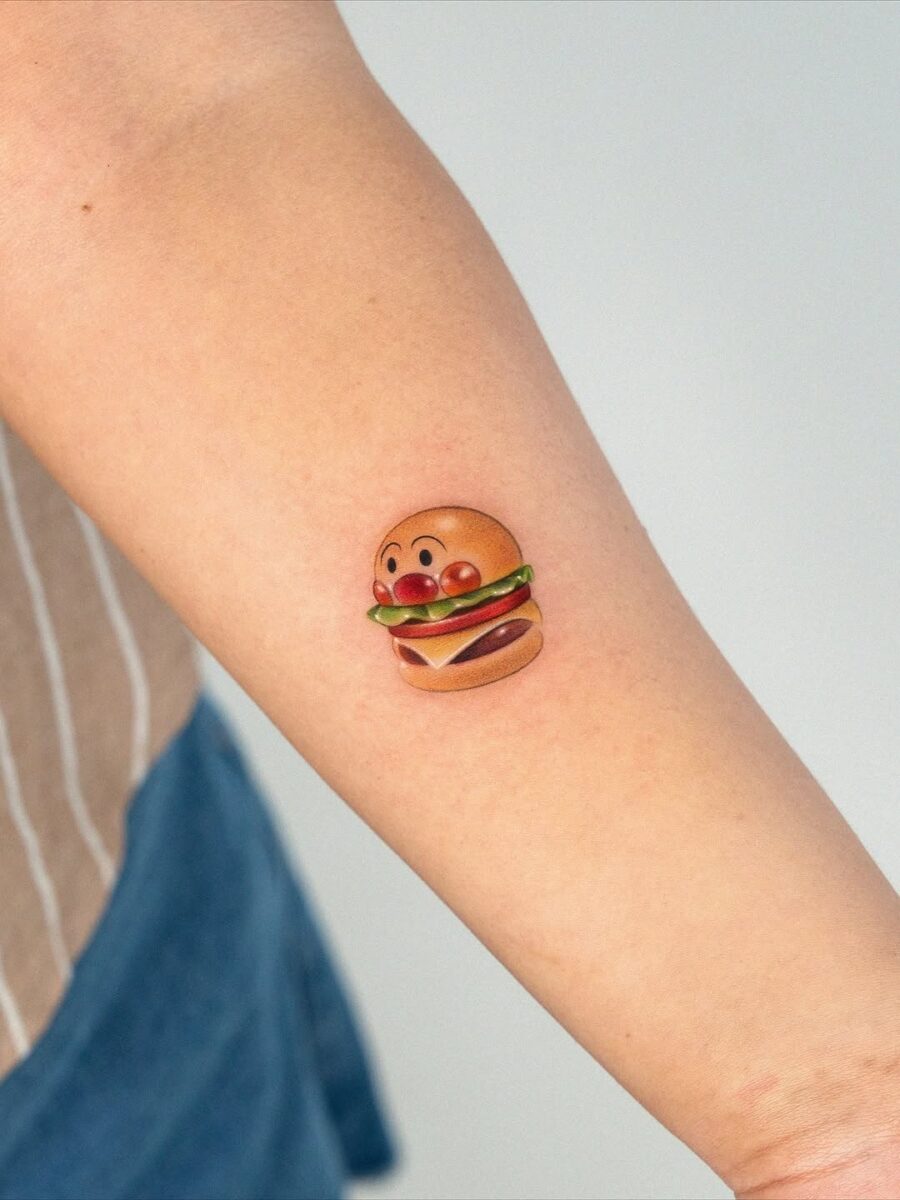 Playful burger tattoo with vibrant colors Tattoo on skin