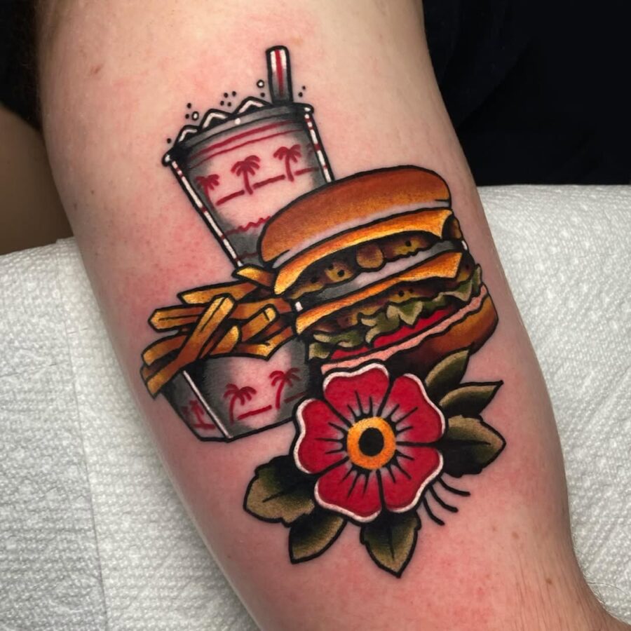 Vibrant burger tattoo with fries and drink Tattoo on skin