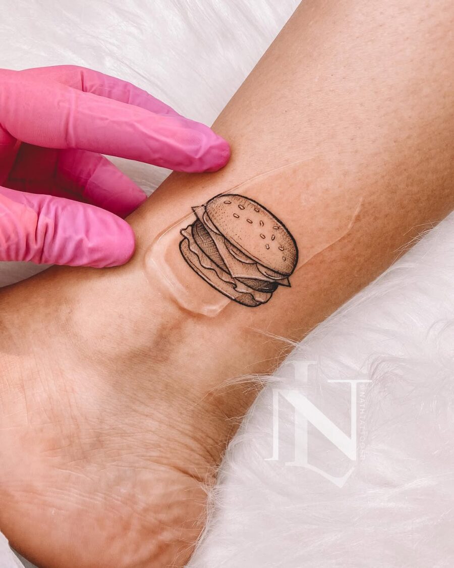 Whimsical burger tattoo on the wrist Tattoo on skin
