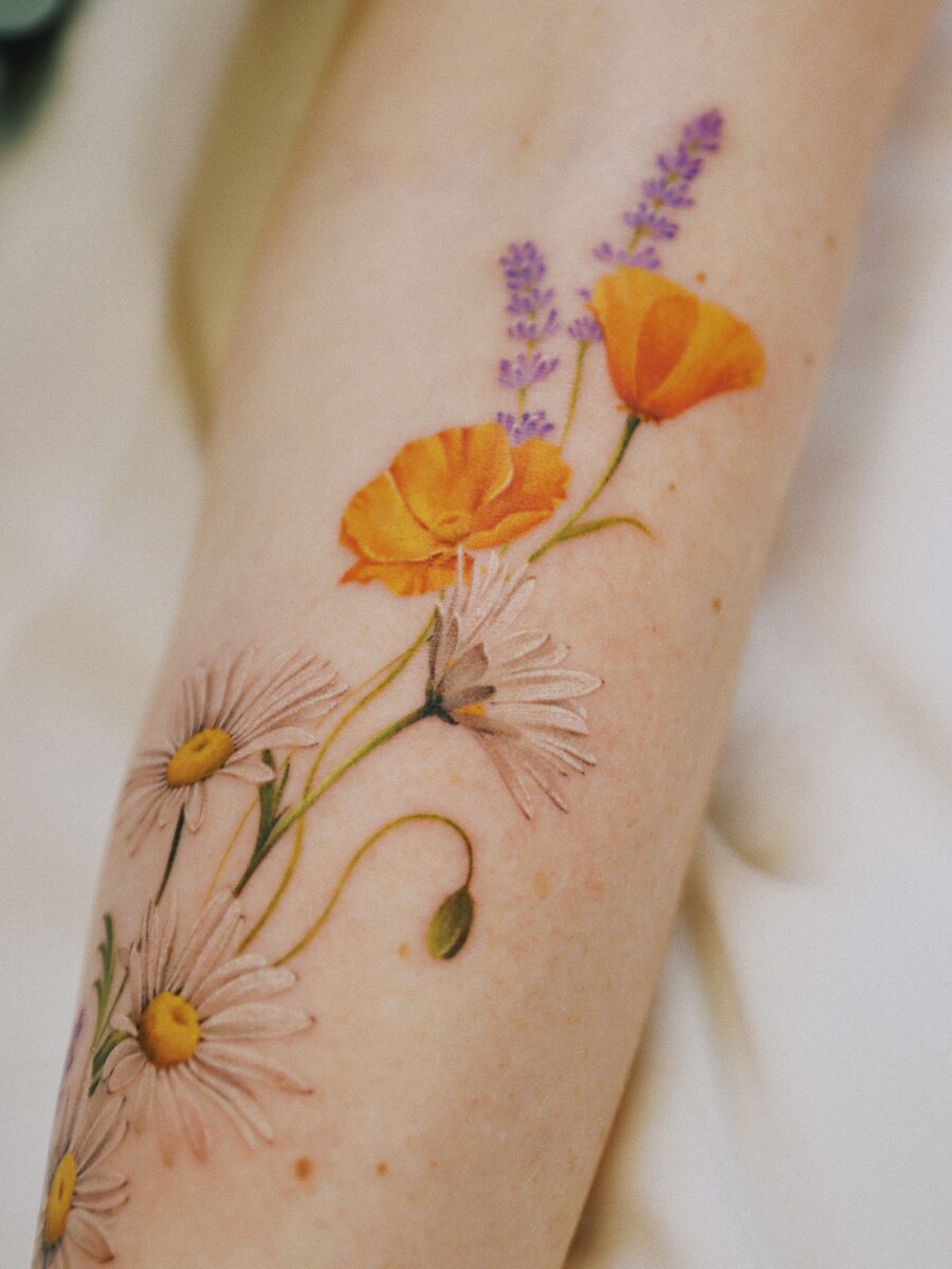 Beautiful buttercup flower tattoo design on arm Tattoo on skin
