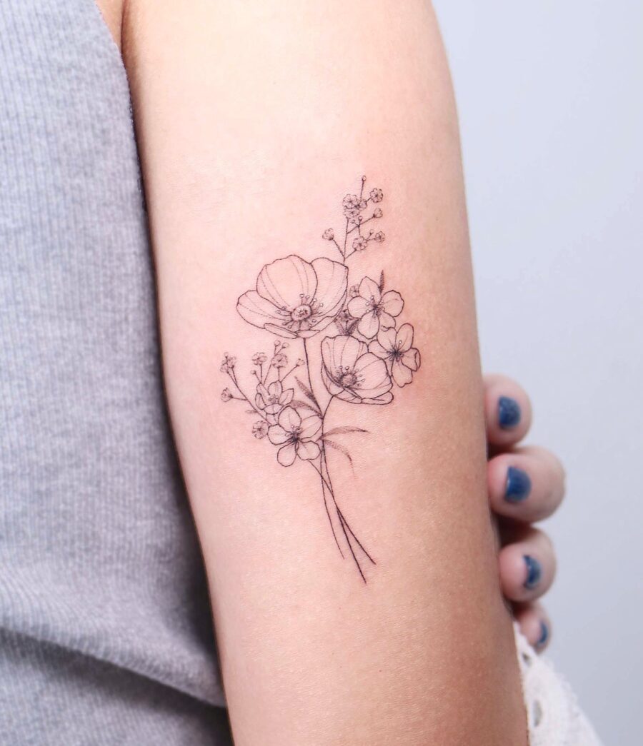 Delicate Buttercup Floral Tattoo Elegantly Embellished Tattoo on skin