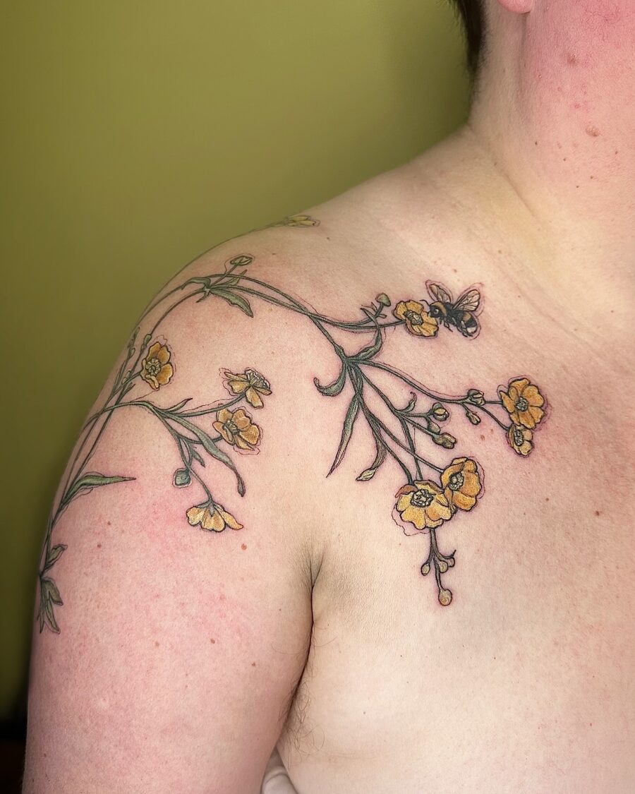 Delicate buttercup floral tattoo with butterfly accent Tattoo on skin