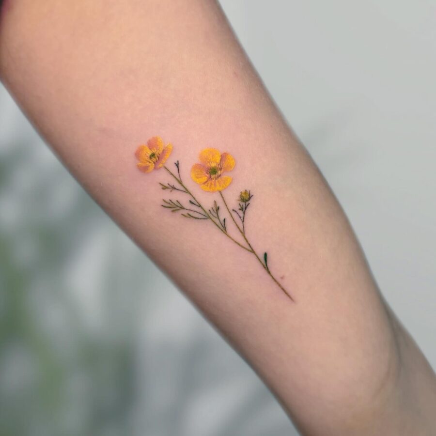 Elegant yellow buttercup flower tattoo on arm Tattoo on skin
