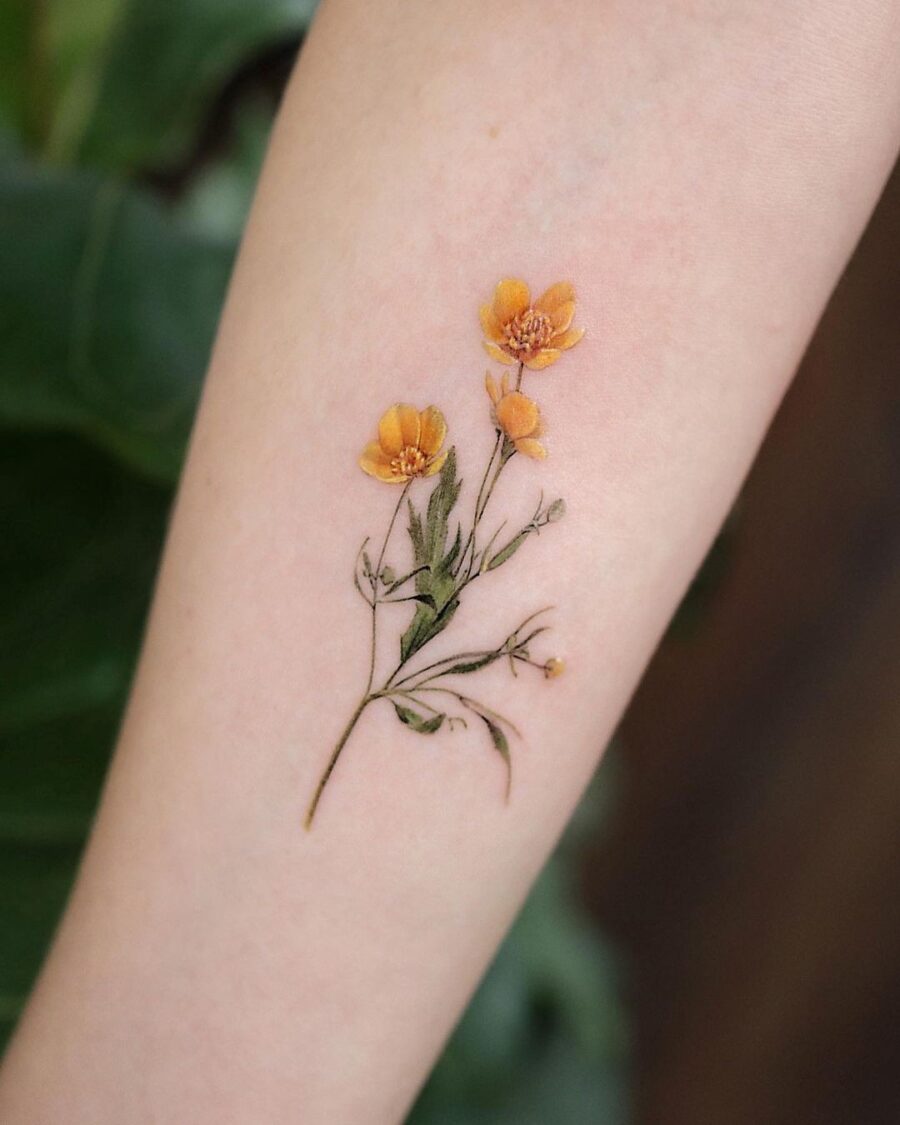Stunning buttercup tattoo showcasing vibrant colors Tattoo on skin