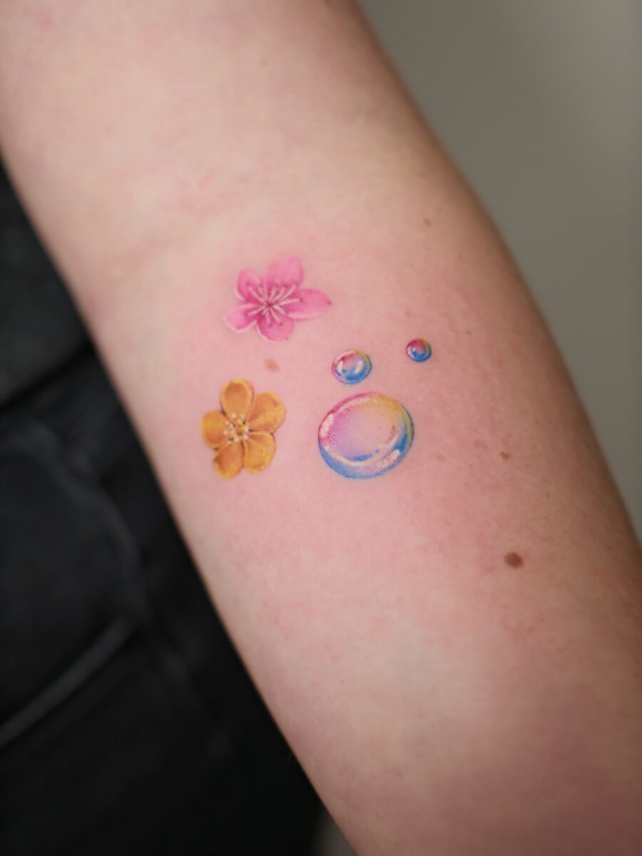 Vibrant buttercup and bubbles tattoo design Tattoo on skin