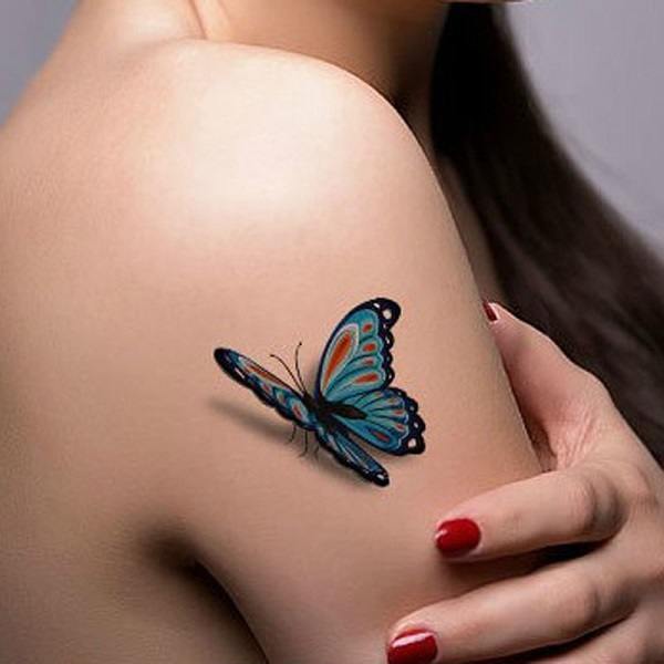 A bluish butterfly tattoo on the arm Tattoo on skin