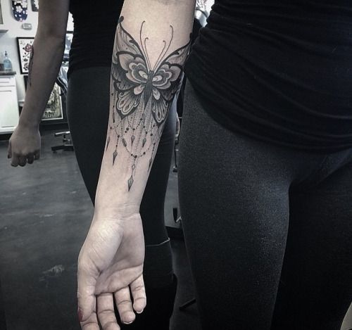 A large dark butterfly tattoos on the arm Tattoo on skin