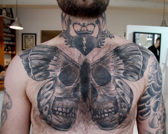 Huge Life-Death Butterfly Hovers Over Chest Tattoo on skin