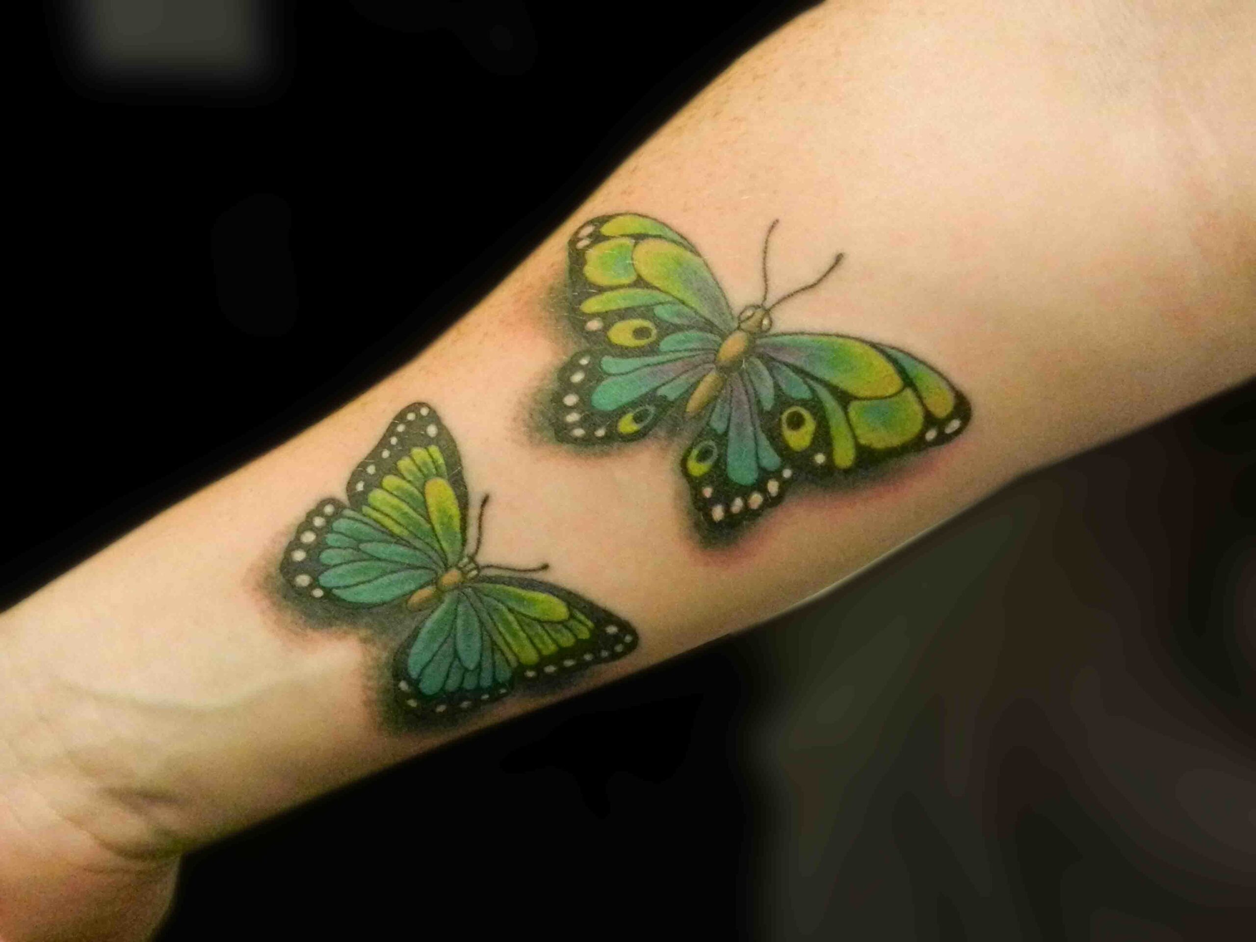 Two Colorful Attractive Butterflies Tattoo on skin