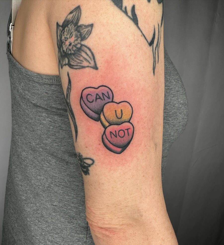 Charming candy heart tattoo with sweet words Tattoo on skin