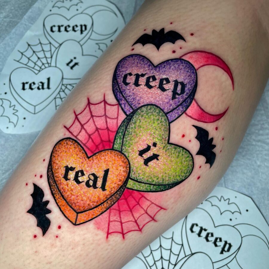 Colorful candy heart tattoo with spooky vibes Tattoo on skin