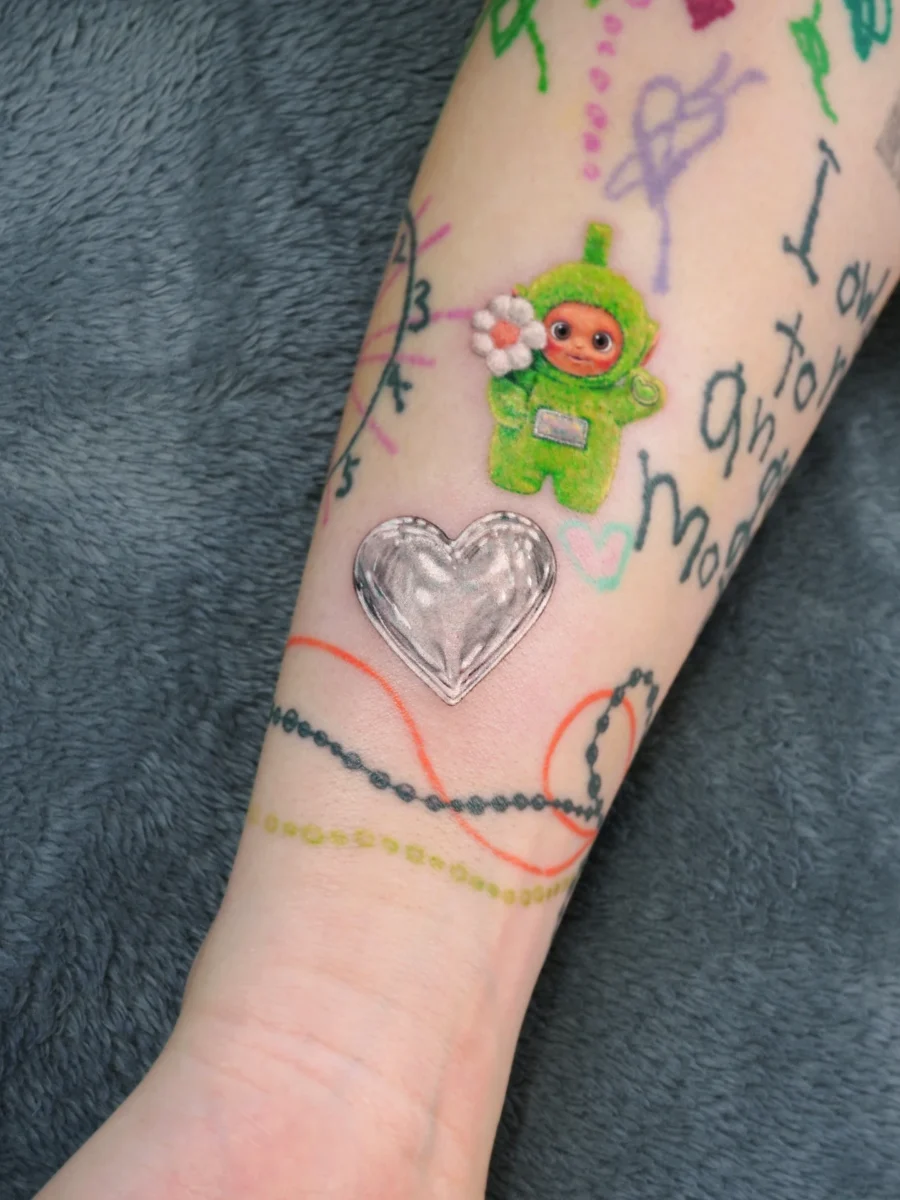 Playful candy heart tattoo with a charming twist Tattoo on skin