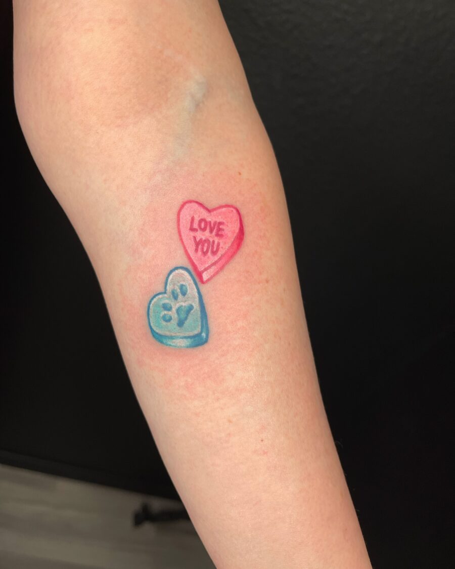 Playful candy heart tattoo with sweet message Tattoo on skin