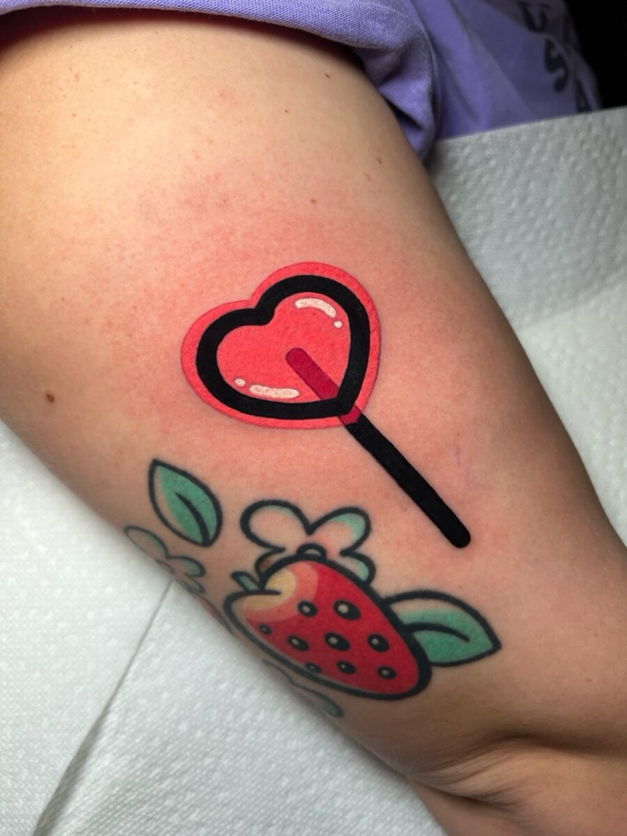 Playful heart-shaped lollipop tattoo design Tattoo on skin
