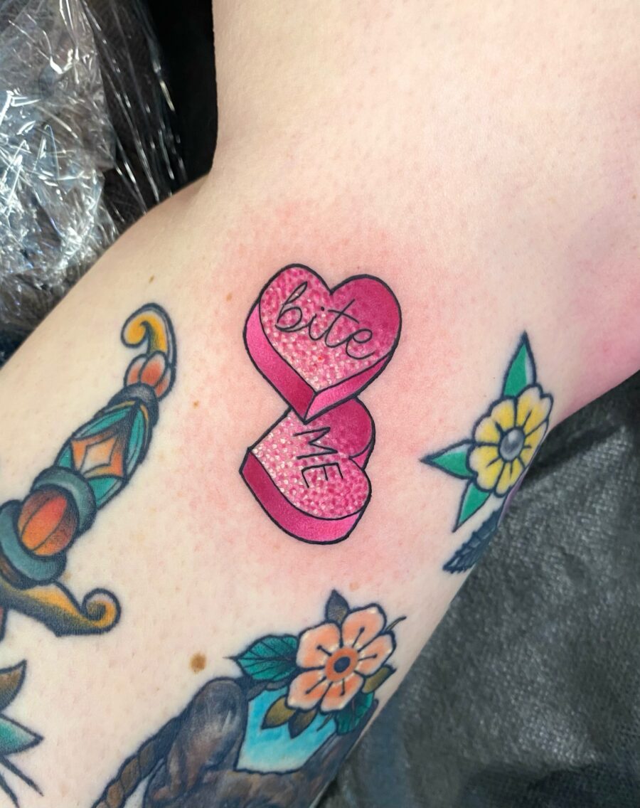 Playful pink candy heart tattoo vibe Tattoo on skin