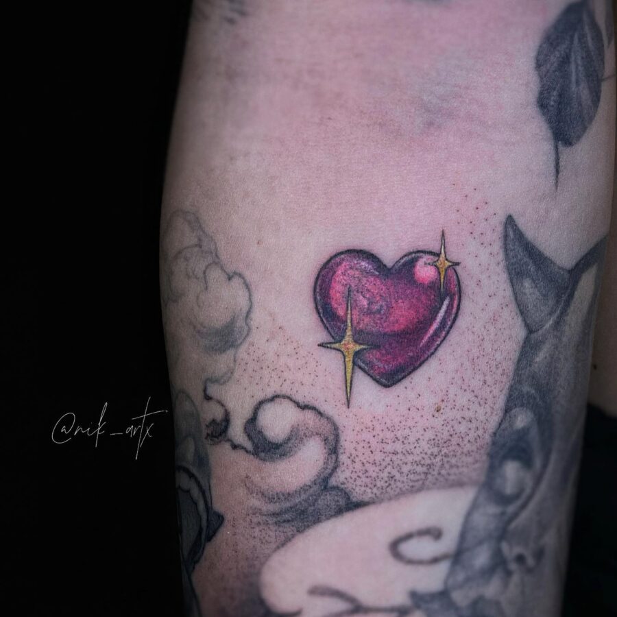 Vibrant candy heart tattoo with shiny accents Tattoo on skin