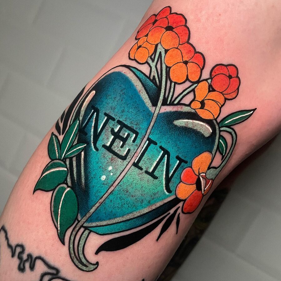Vibrant heart tattoo with a bold message Tattoo on skin