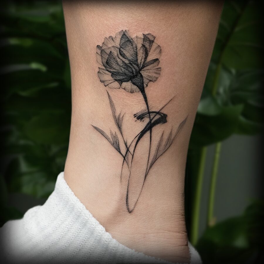 Artistic carnation tattoo in black ink design Tattoo on skin