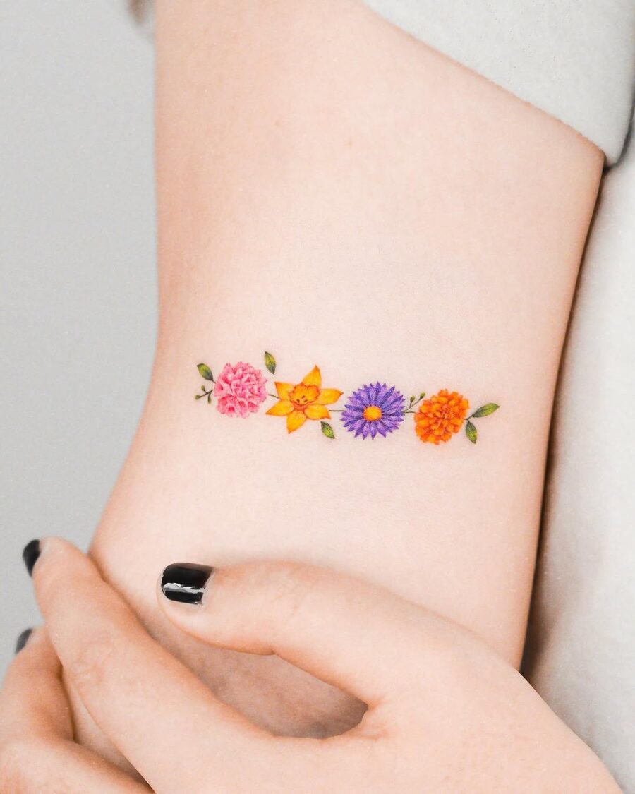 Colorful floral arrangement tattoo on inner arm Tattoo on skin