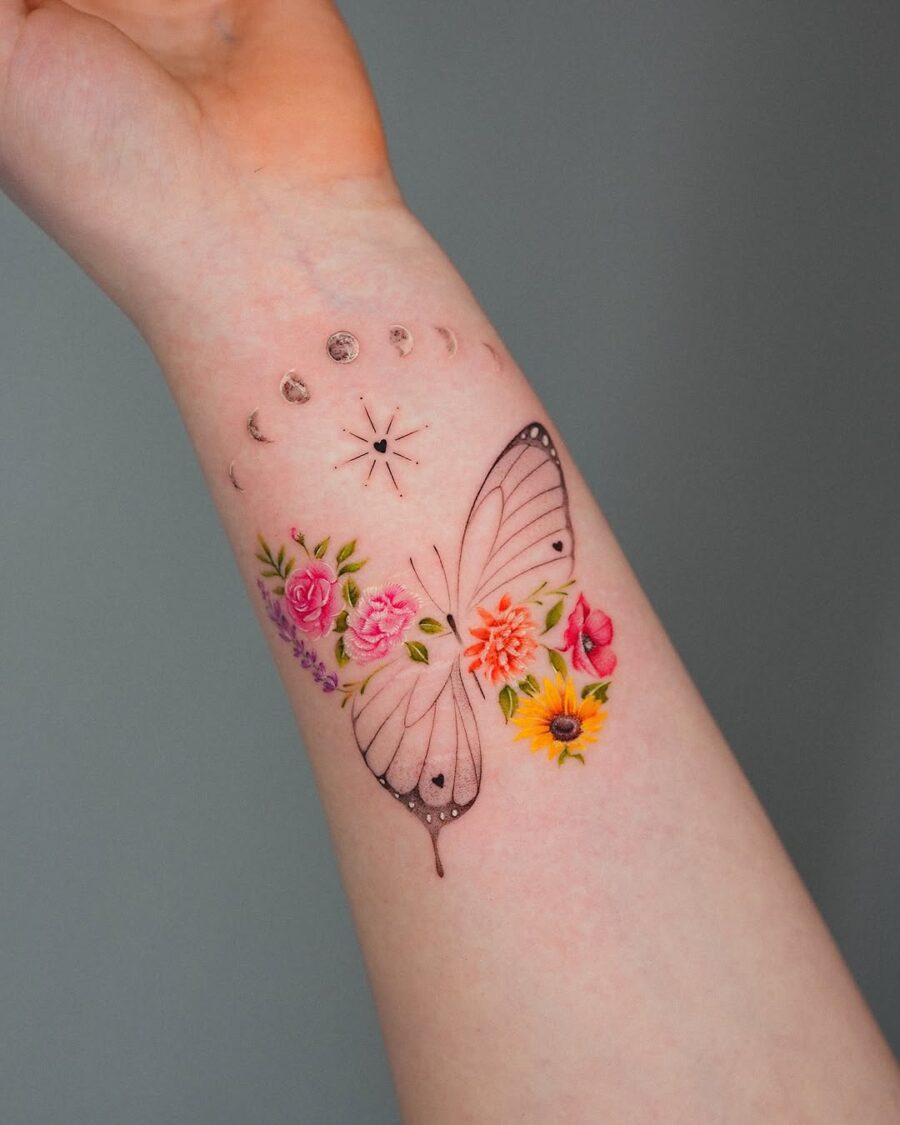 Delicate butterfly tattoo surrounded by floral elements Tattoo on skin