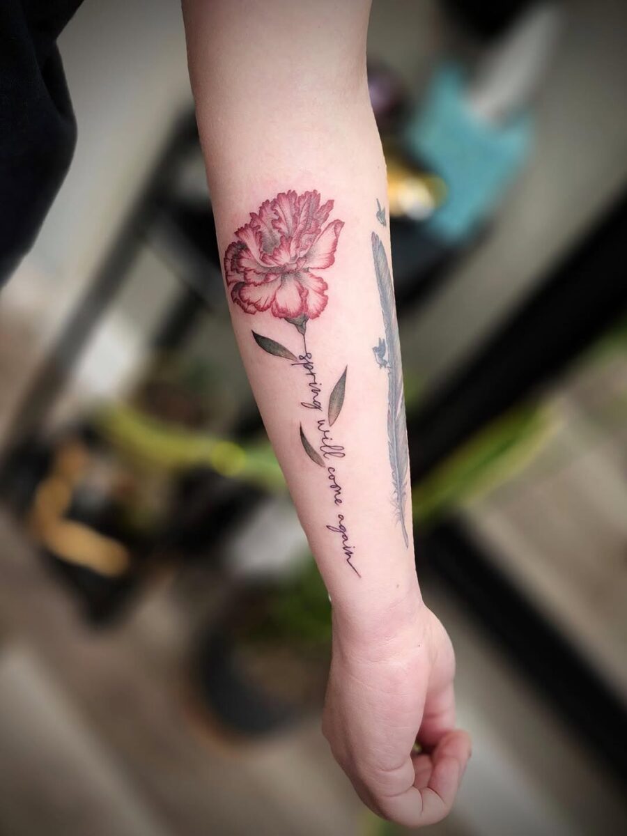 Delicate carnation tattoo on a wrist Tattoo on skin