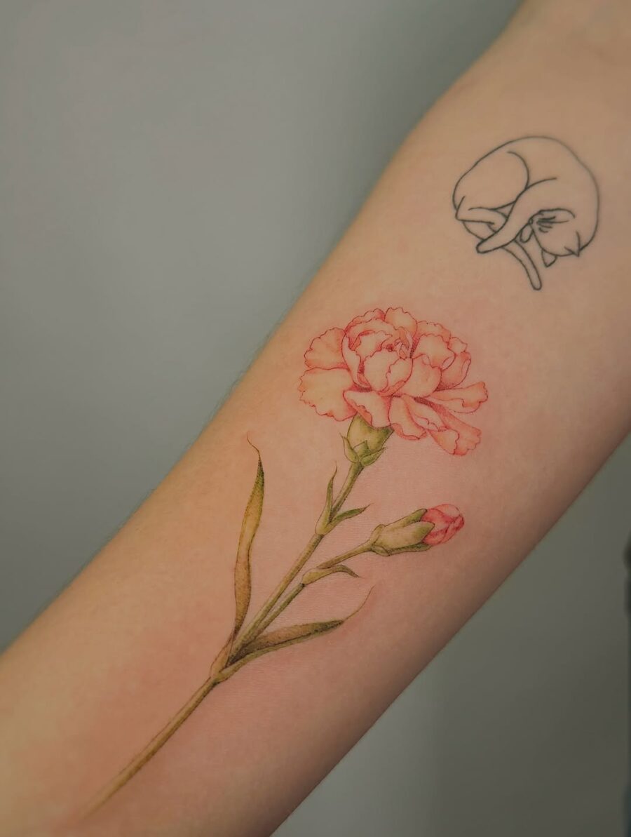 Elegant Carnation Tattoo Blending Realism and Art Tattoo on skin