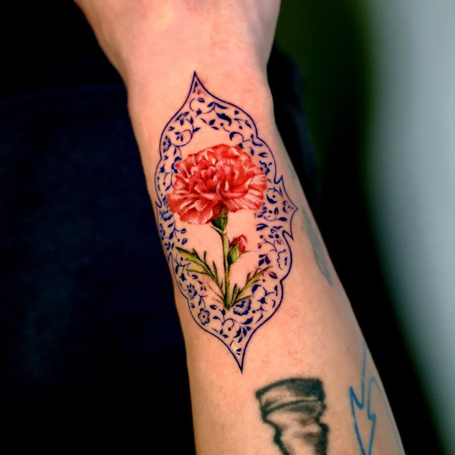 Elegant carnation tattoo with ornate detailing Tattoo on skin