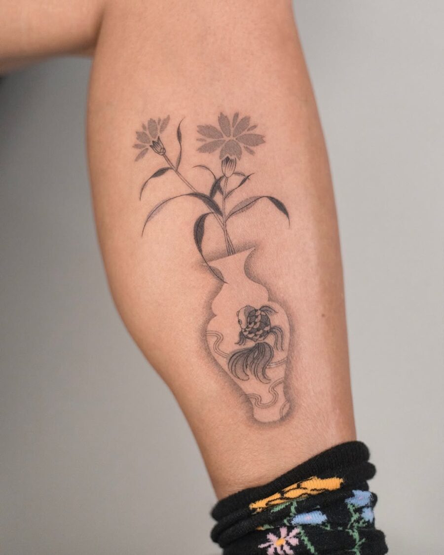 Elegant vase inked with delicate flowers Tattoo on skin