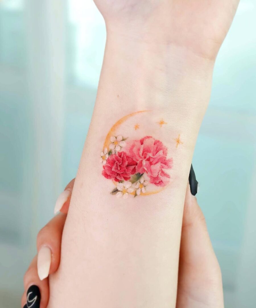 Vibrant Carnation Tattoo with Celestial Elements Tattoo on skin