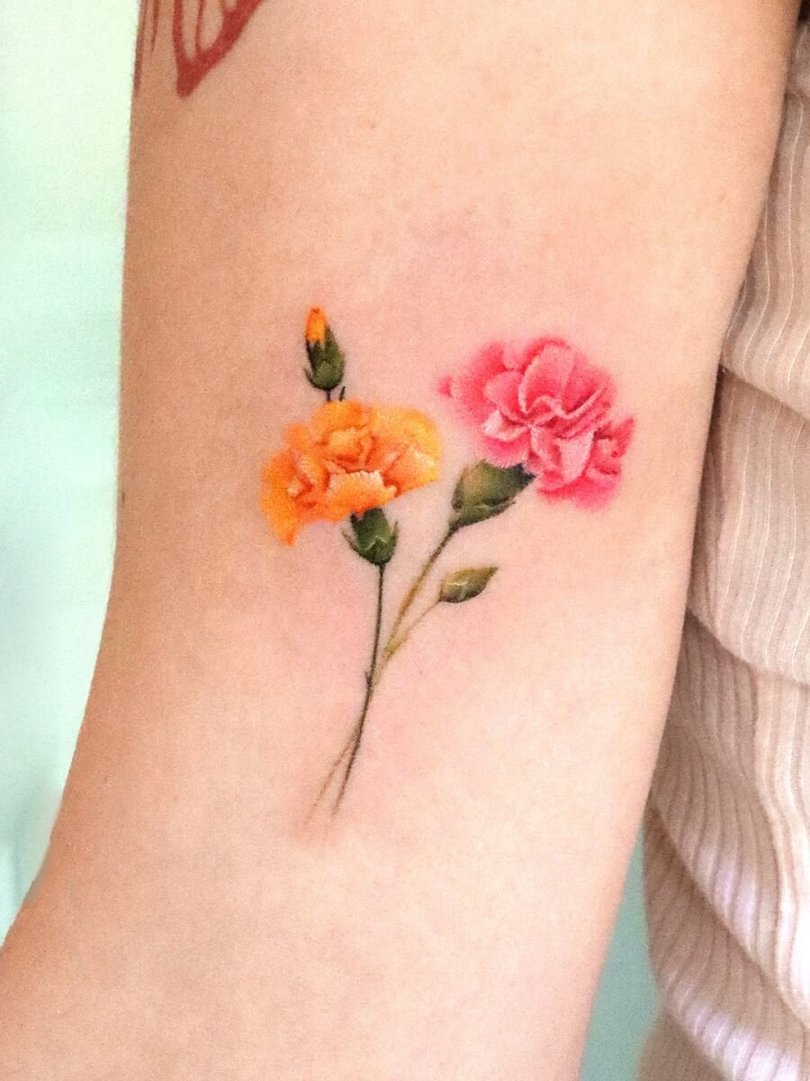 Vibrant carnation tattoo with floral elegance Tattoo on skin