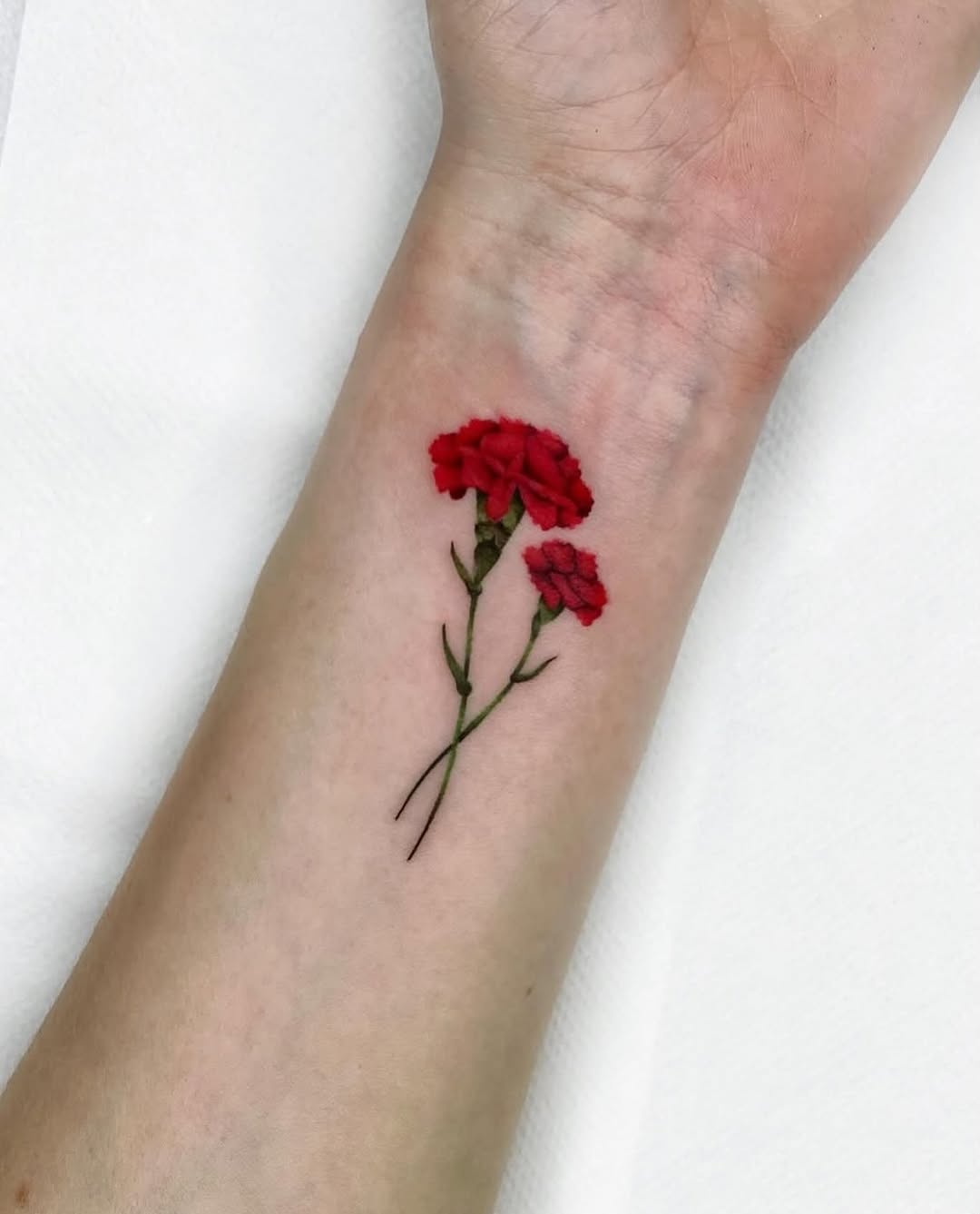 Vibrant Red Carnation Tattoo on Forearm Tattoo on skin