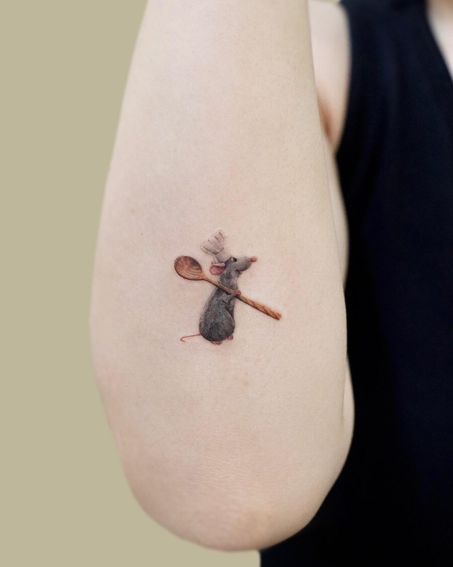 Charming cartoon mouse tattoo with a spoon Tattoo on skin
