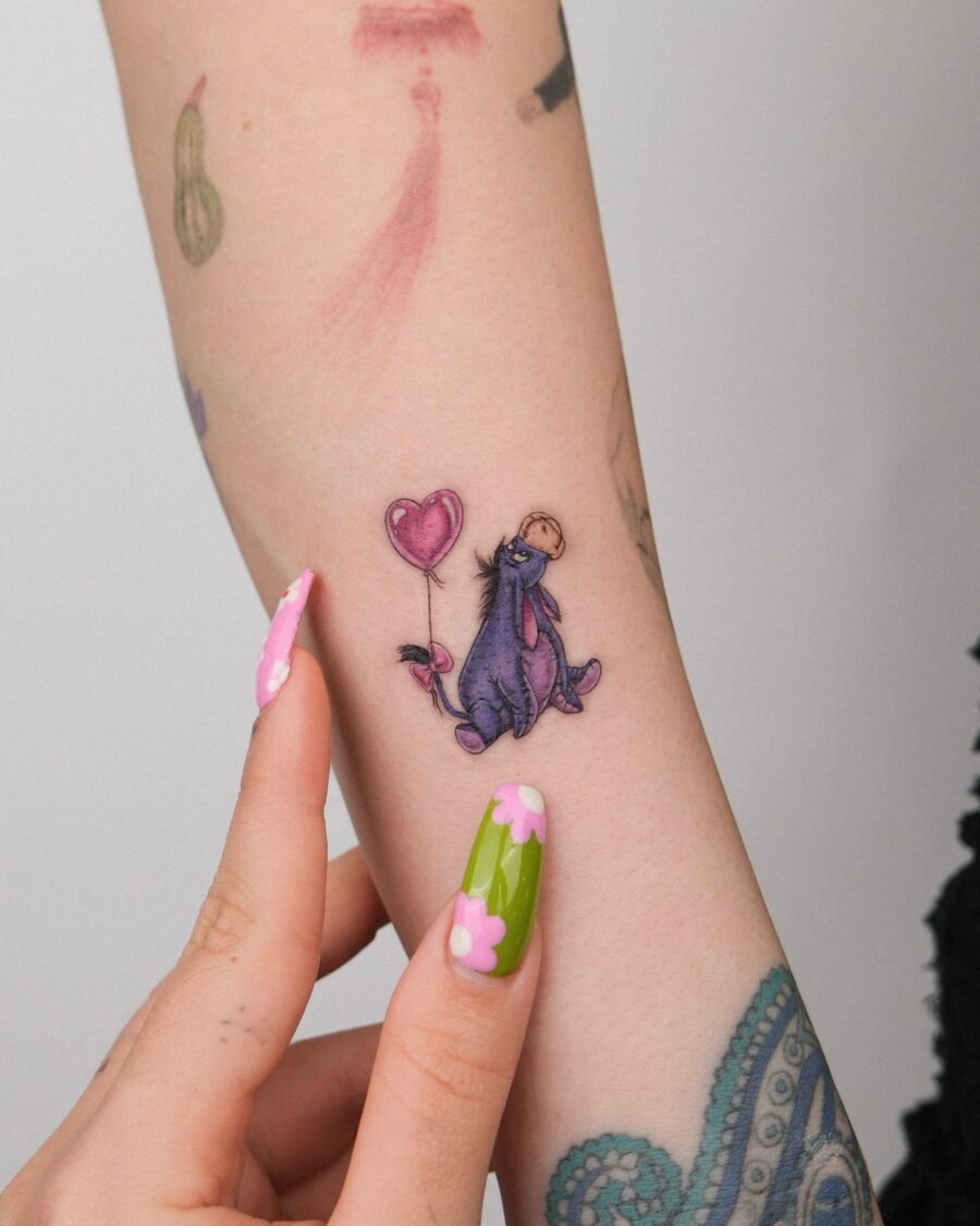 Charming Eeyore Tattoo with a Heart Balloon Tattoo on skin