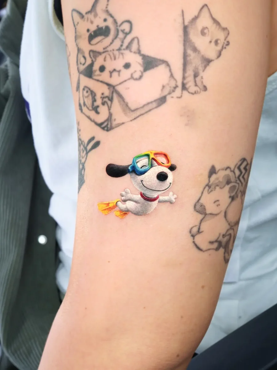 Whimsical dog tattoo with colorful sunglasses Tattoo on skin