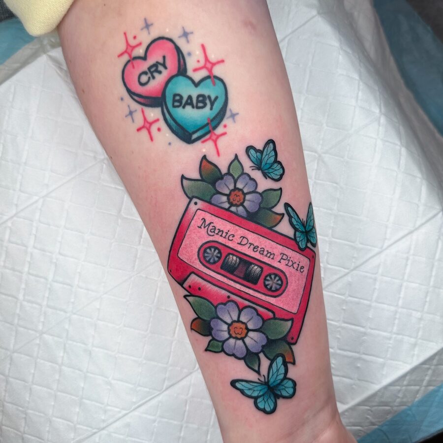 Colorful cassette tape surrounded by vibrant flowers Tattoo on skin
