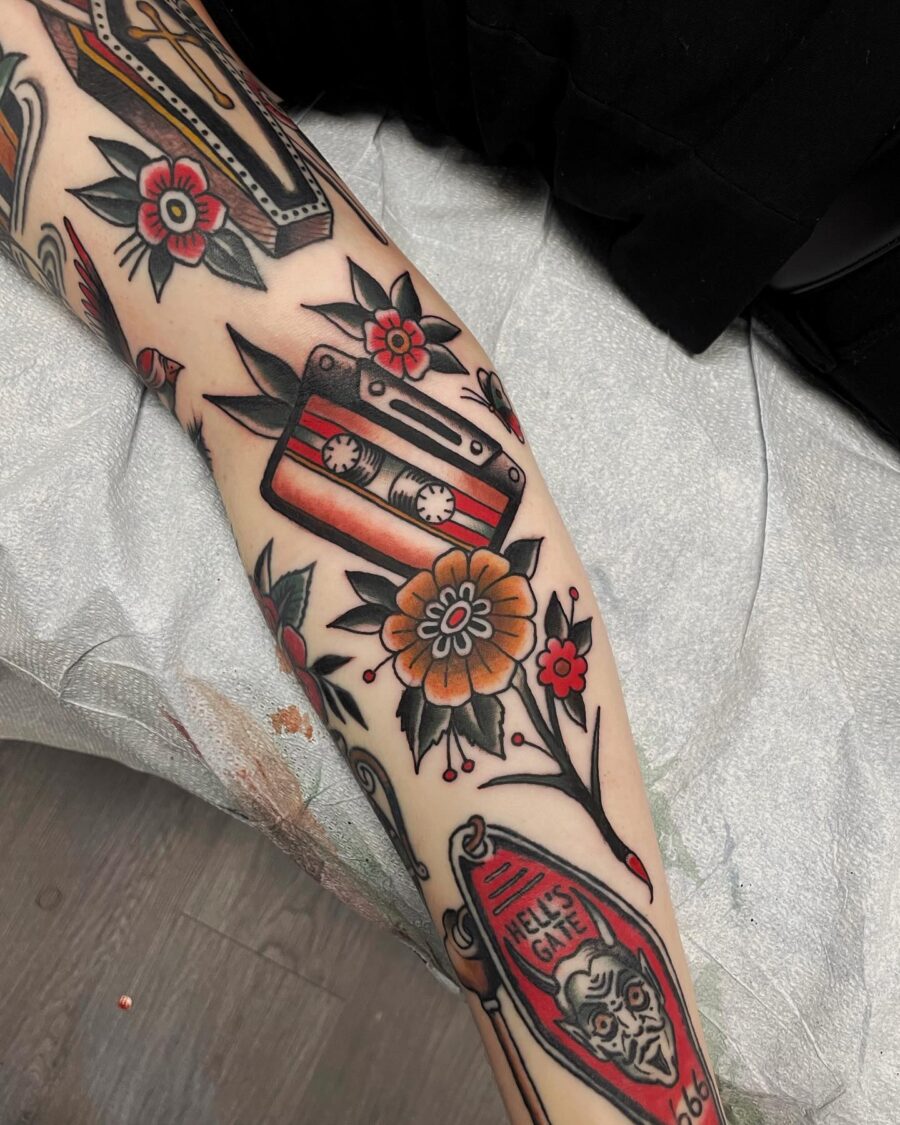 Colorful cassette tape tattoo with floral elements Tattoo on skin