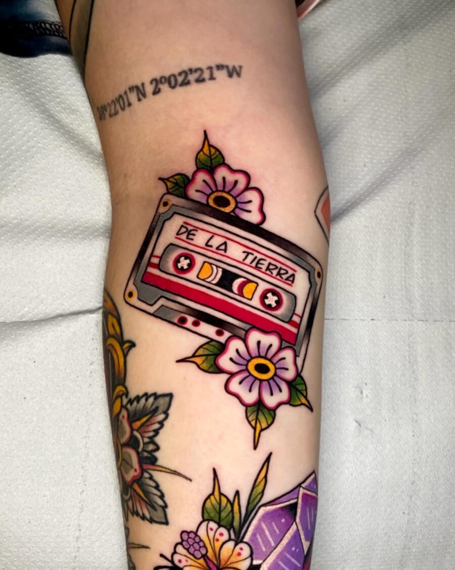 Colorful cassette tattoo with floral accents Tattoo on skin