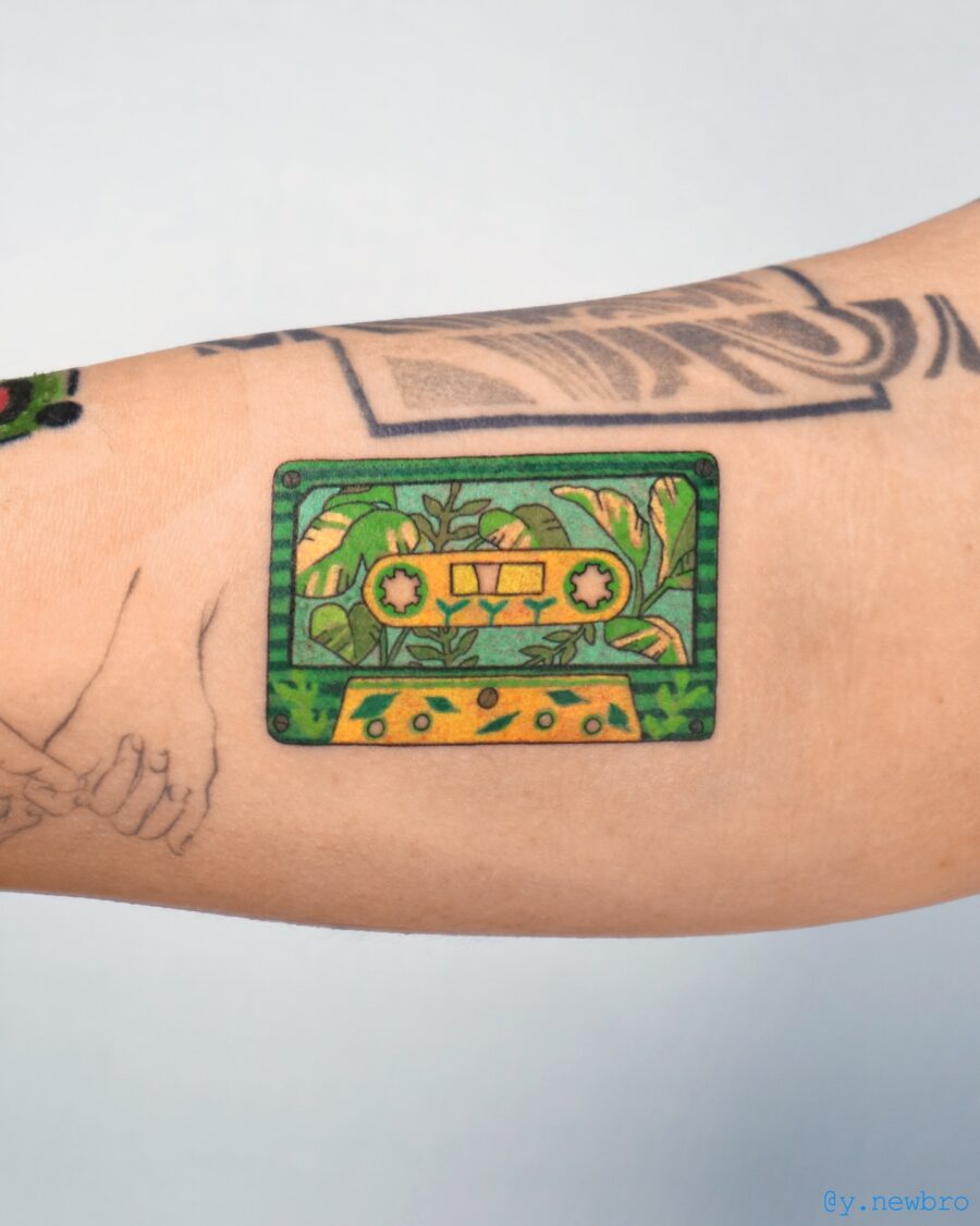 Colorful cassette tattoo with lush plant details Tattoo on skin