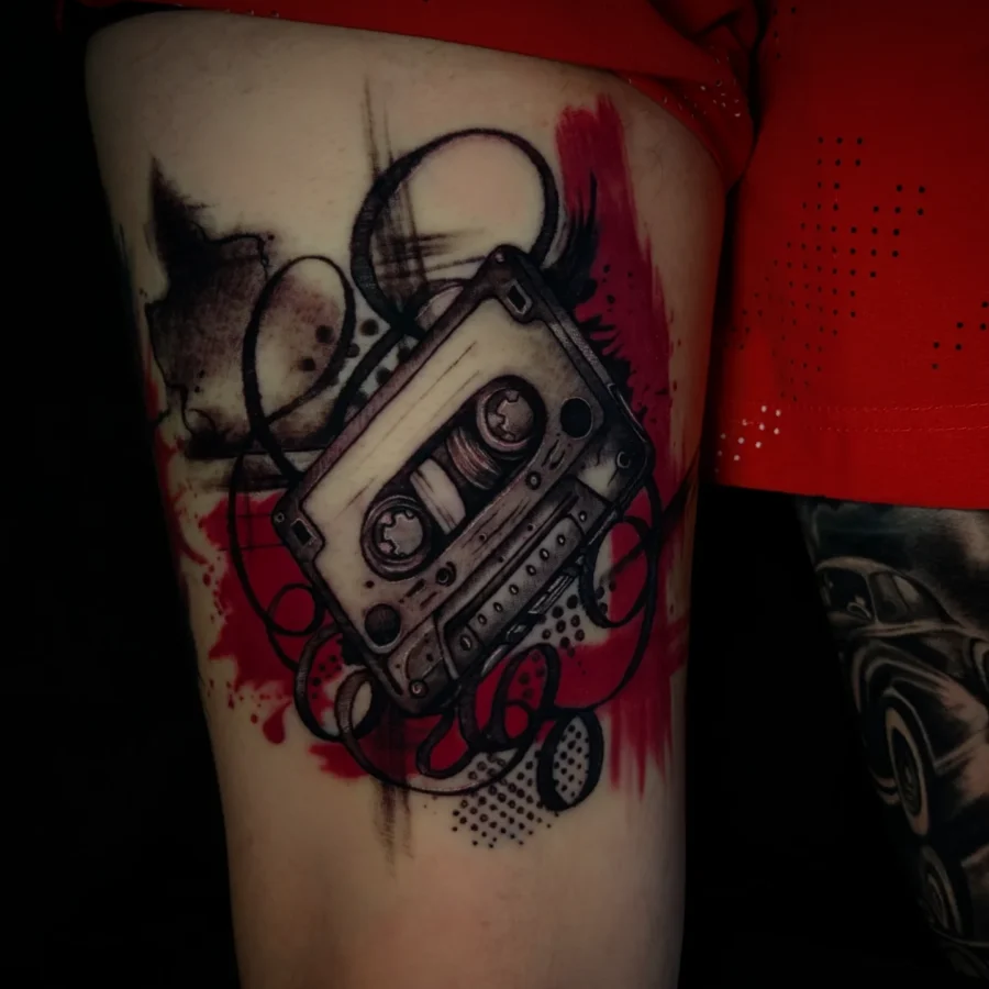 Stylish black and red cassette tape tattoo Tattoo on skin