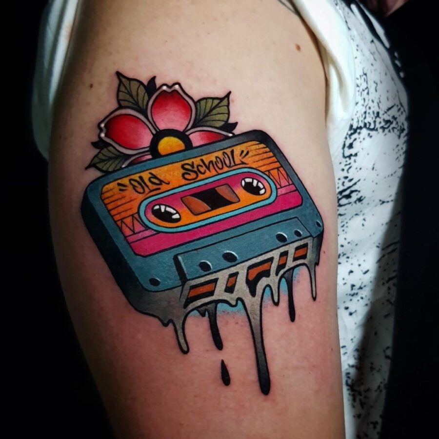 Vibrant cassette tape tattoo with floral details Tattoo on skin