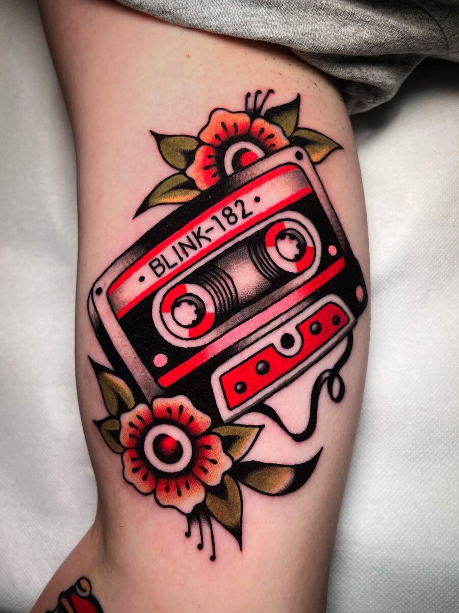 Vibrant cassette tattoo with floral accents Tattoo on skin