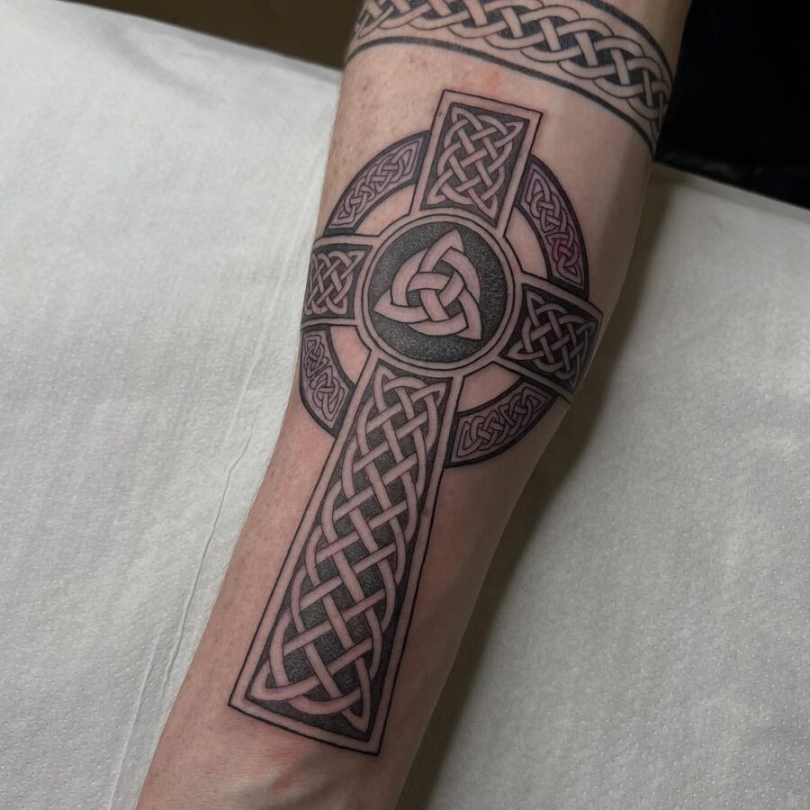 Intricate Celtic cross tattoo on forearm Tattoo on skin