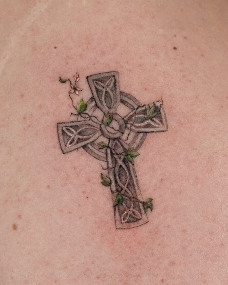 Intricate Celtic cross with nature elements Tattoo on skin