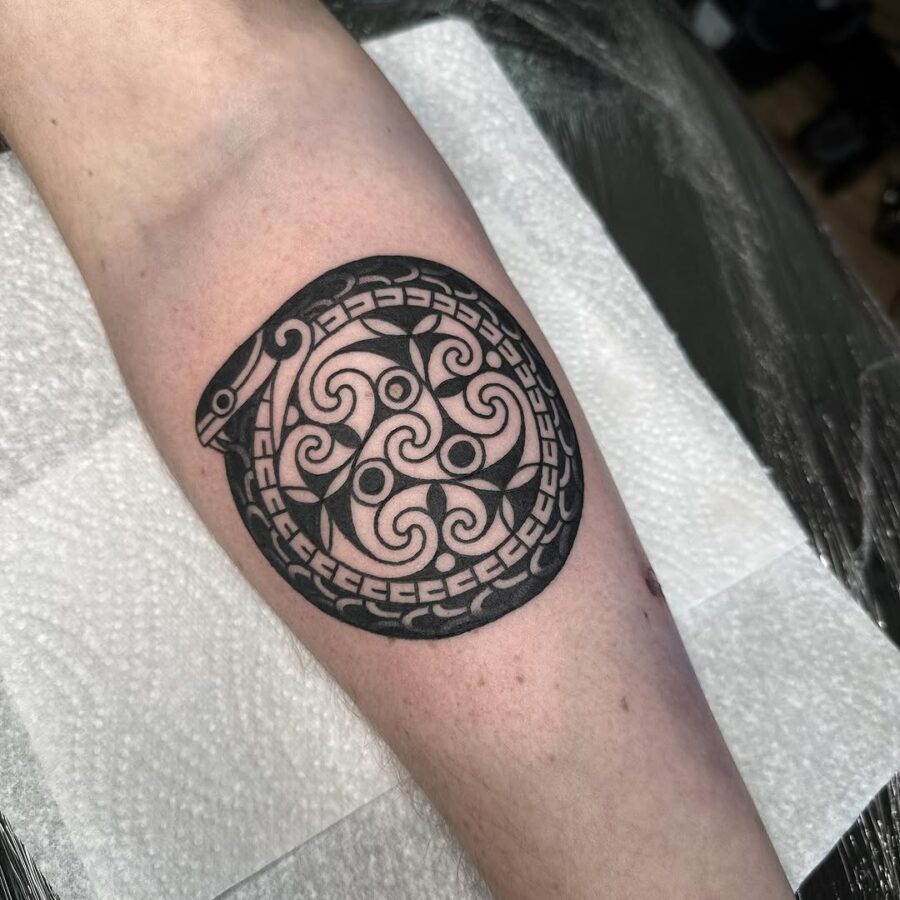 Intricate Celtic snake tattoo in circular design Tattoo on skin