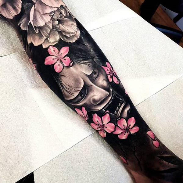 The Downcast Face and Bright Blossoms Tattoo on skin