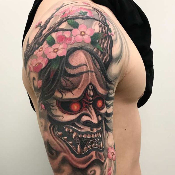 The Glowing Skull with Cherry Blossom Crown Tattoo on skin