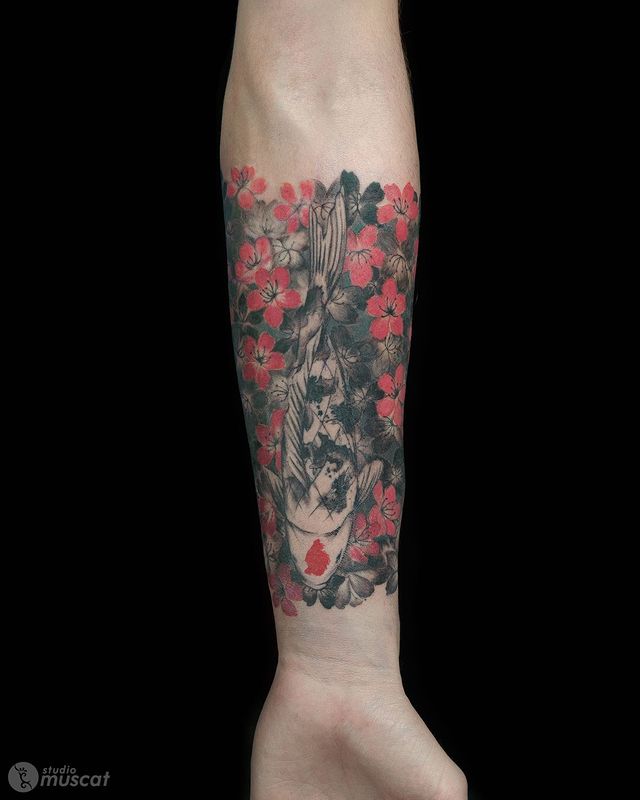 The Koi Fish Swimming Through Flowers Tattoo on skin