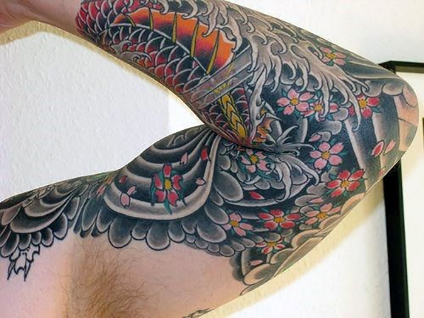 The Wave, the Fish, and the Flowers Tattoo on skin